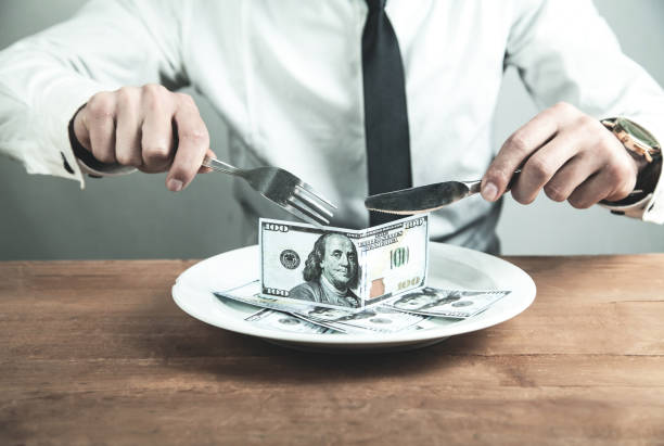 istock Caucasian businessman having dinner dollars. Business concept 1023671582