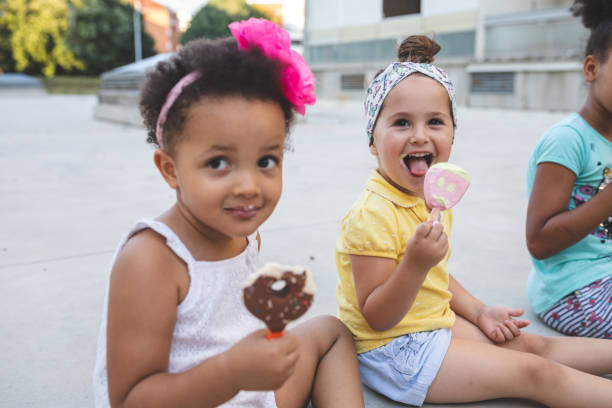 istock Cheerful mixed race siblings eating ice cream outdoors together 1023671630
