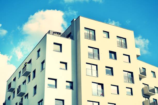 istock Modern apartment building exterior. Retro colors stylization 1023672060