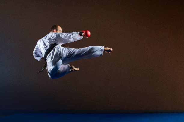 istock A man with a black belt trains a kick in a jump 1023680410