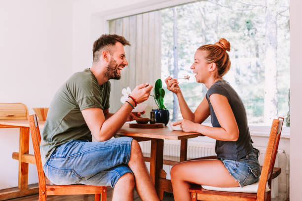 istock Young couple eating cereal breakfast at dining room table 1023683458