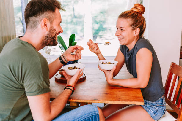 istock Young couple eating cereal breakfast at dining room table 1023683466