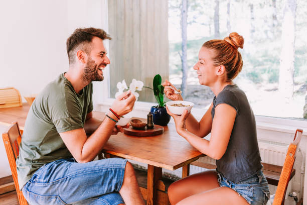 istock Young couple eating cereal breakfast at dining room table 1023683470