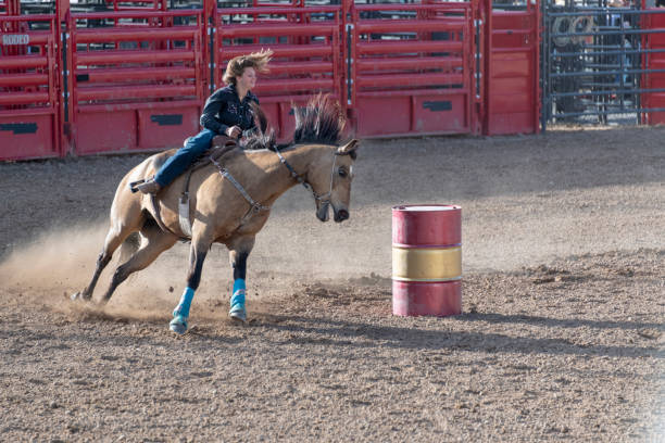 istock Cowgirl barrel racing at rodeo 1023692020