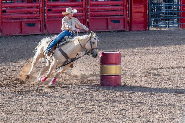 istock Cowgirl barrel racing at rodeo 1023692028