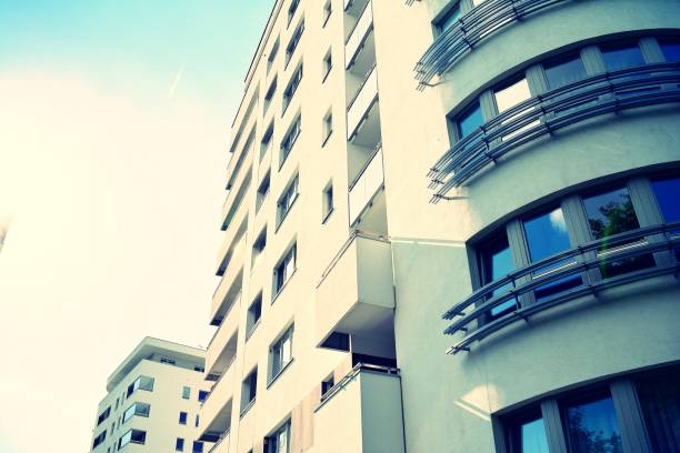 istock Modern apartment building exterior. Retro colors stylization 1023712092