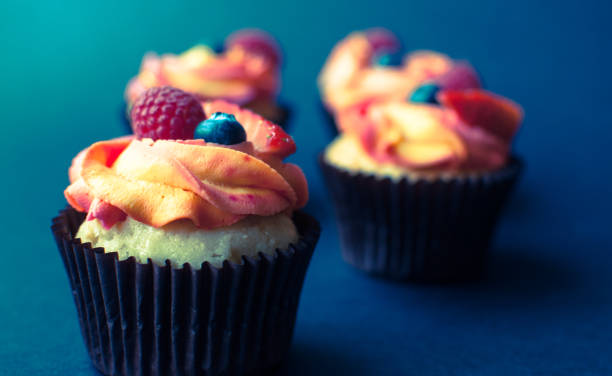 istock Tasty cupcake with fresh fruit on dark background. 1023712364