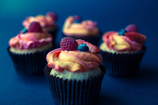 istock Tasty cupcake with fresh fruit on dark background. 1023712382