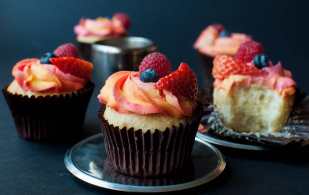 istock Tasty cupcake with fresh fruit on dark background. 1023712450