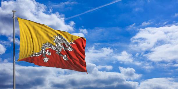 istock Bhutan flag on a blue sky background. 3d illustration 1023716502