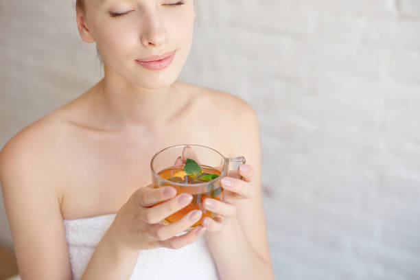 istock Caucasian smiling woman after spa covered with white towel 1023724008