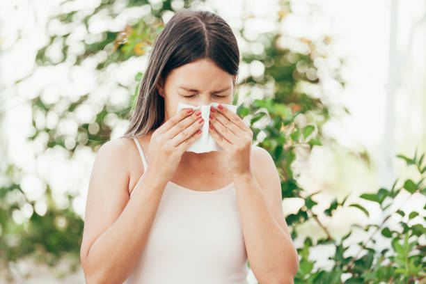 istock Woman with allergy symptom blowing nose 1023726508