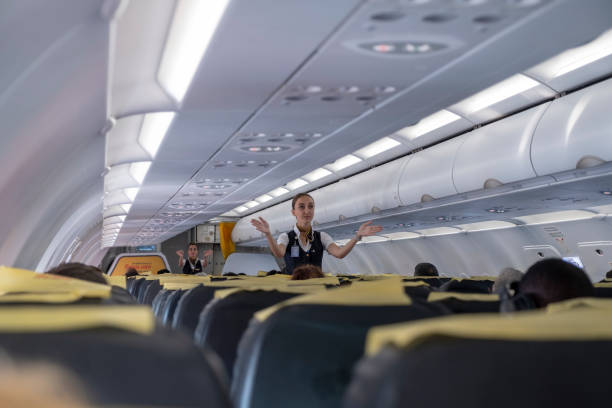 air hostess giving safety instructions before flight - airplane air vehicle business travel passenger imagens e fotografias de stock