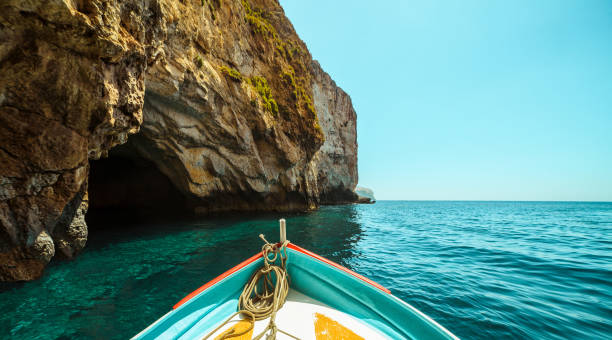 Sailing in the Mediterranean boat tour near the coast in Malta grotto cave photos stock pictures, royalty-free photos & images