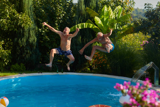 istock Senior Friends Pool Fun 1023735380