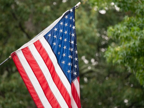 istock United States Flag in Rain Storm 1023738356