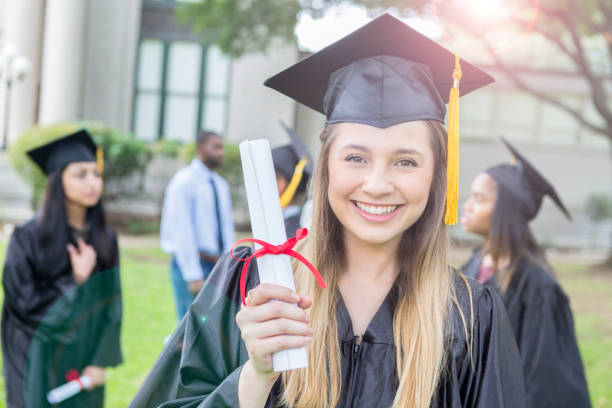 istock Young woman shows off college diploma 1023742048