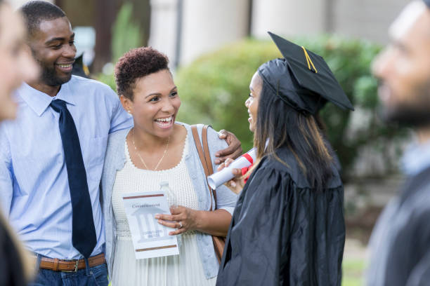 istock Female graduate talks with parents after ceremony 1023742054