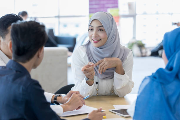 istock Confident businesswoman talks with a group of clients 1023744266