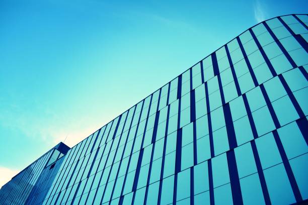 istock Modern office building on a clear sky background. Retro stylized colorful tonal filter effect 1023754350