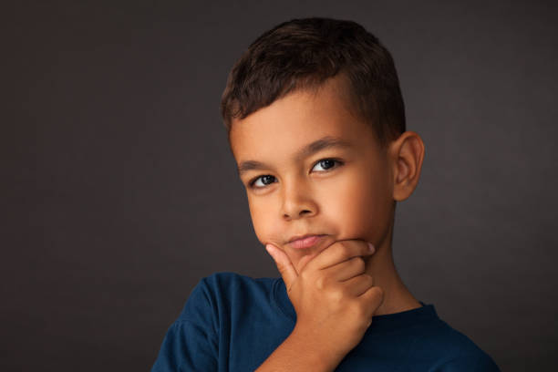 istock studio portrait of a 10 year old schoolboy on a black background 1023754438