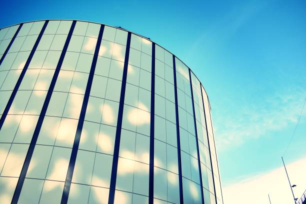 istock Modern office building on a clear sky background. Retro stylized colorful tonal filter effect 1023754458