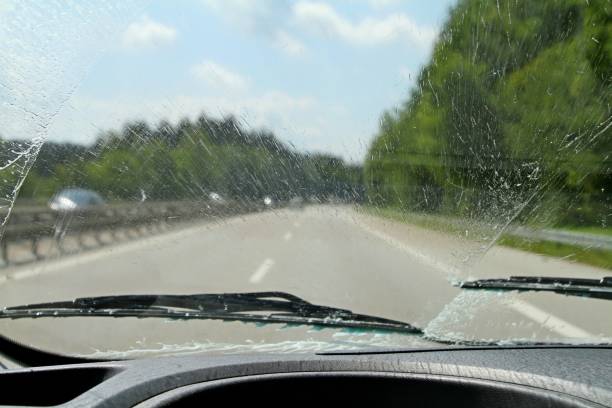istock inside vehicle view of windscreen wipers in rain 1023754560