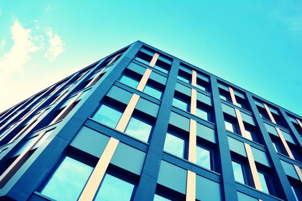 istock Modern office building on a clear sky background. Retro stylized colorful tonal filter effect 1023759086