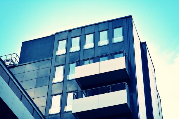 istock Modern office building on a clear sky background. Retro stylized colorful tonal filter effect 1023759354