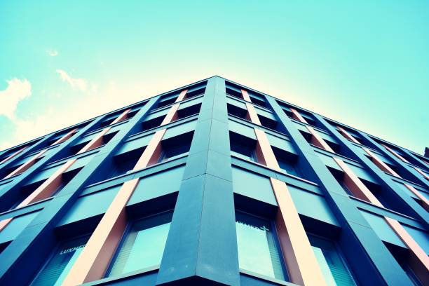 istock Modern office building on a clear sky background. Retro stylized colorful tonal filter effect 1023764198