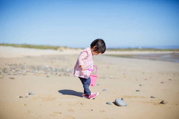baby girl playing at summer beach