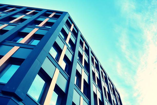 istock Modern office building on a clear sky background. Retro stylized colorful tonal filter effect 1023766680