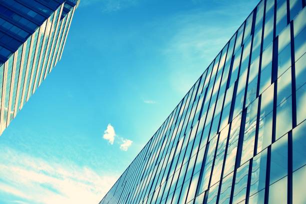 istock Modern office building on a clear sky background. Retro stylized colorful tonal filter effect 1023766740