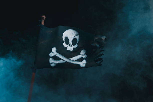 Pirate flag waving with the wind on a smoky background