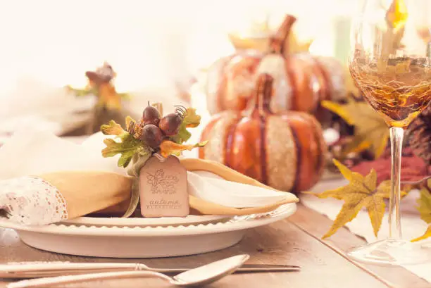 Photo of Thanksgiving holiday autumn place setting with place card