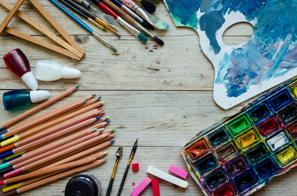 istock Artist paint brushes on the wooden background 1023769642