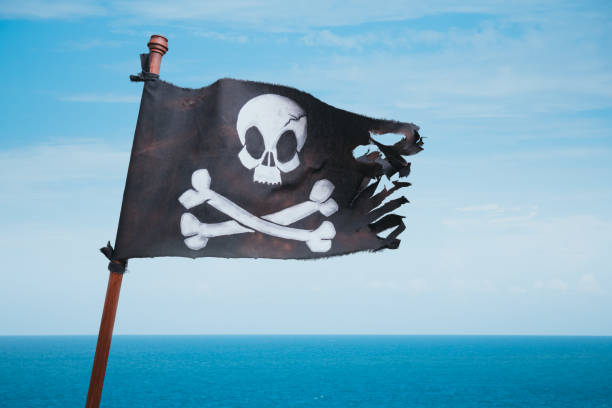 istock Pirate flag waving at sea 1023769812