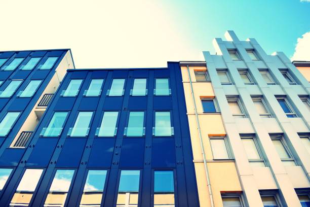 istock Modern office building on a clear sky background. Retro stylized colorful tonal filter effect 1023772552