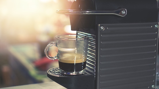 modern coffee machine making espresso from capsules coffee