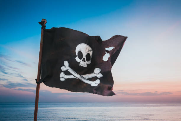 istock Pirate flag waving at sea 1023775584