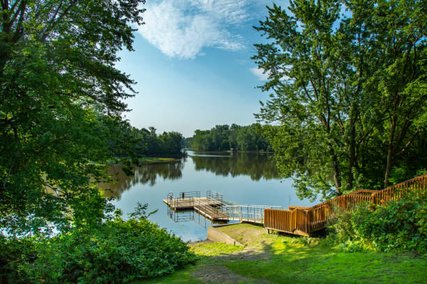 istock Dock on a river on a summer morning with blue sky 1023780274