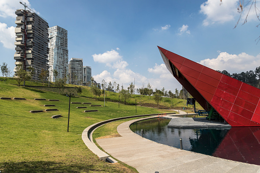 modern park in Santa Fe, Mexico City with tall buildings in the back