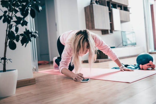 istock Female Athlete Setting Up Mobile Phone For Workout 1023797922