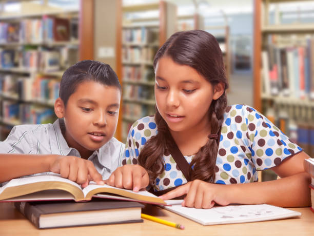 istock Hispanic Boy and Girl Having Fun Studying Together In The Library 1023806854