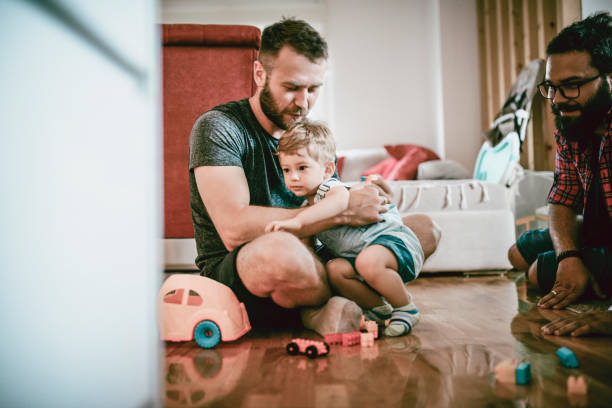 istock Homosexual Couple Playing With Their Adopted Son 1023807320