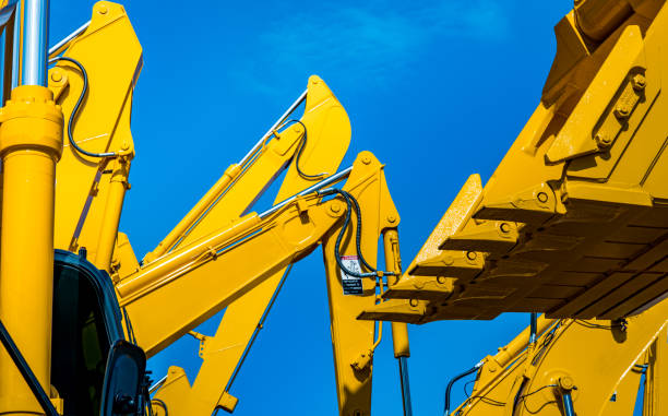 istock Yellow backhoe with hydraulic piston arm against clear blue sky. Heavy machine for excavation in construction site. Hydraulic machinery. Huge bulldozer. Heavy industry 1023829210