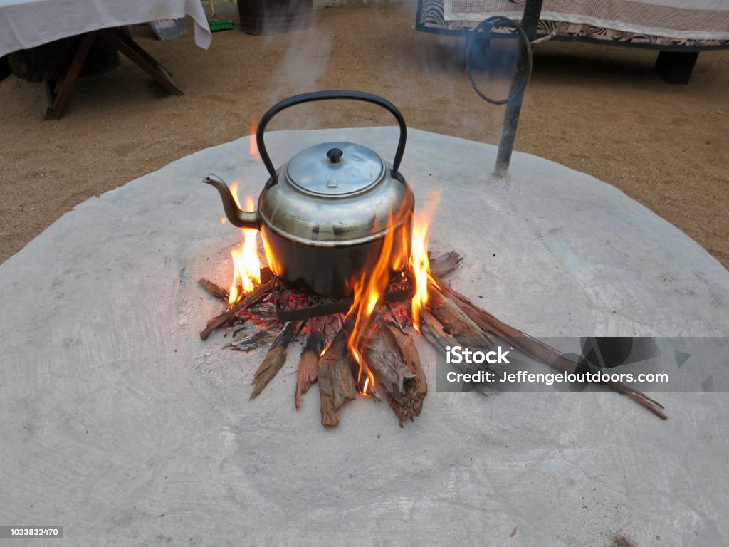 Outdoor Camping Teapot Cooking In Fire Pit Stock Photo - Download Image Now  - Adventure, Barbecue Grill, Boiling - iStock