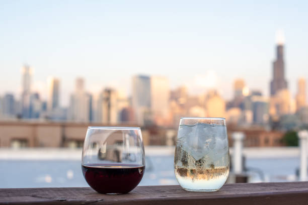 Wine glasses on a rooftop in the city Wine glasses ready to be enjoyed on a rooftop with a beautiful cityscape blurred in the background. balcony BAR stock pictures, royalty-free photos & images