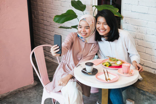 istock Two asian women spending time together at cafe 1023848032