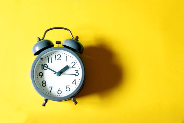 istock Alarm clock on a bright  yellow background , time management concept 1023848192